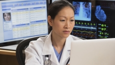 Healthcare technician reviewing MRI data