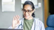 Healthcare professional engaging remotely via a laptop computer