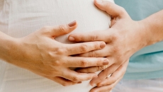 Hands touching a baby bump