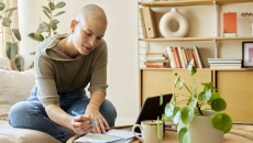 Person sitting in a home while looking at a laptop