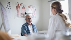 Healthcare provider sitting with a patient in the clinical setting