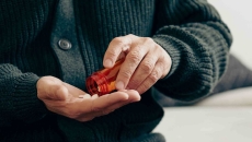 Person pouring pills into their hand