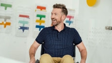 A smiling person in a wheelchair