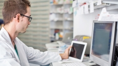 Healthcare professional looking at data on a screen