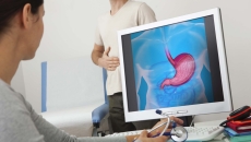 Gastroenterology exam with screen showing stomach