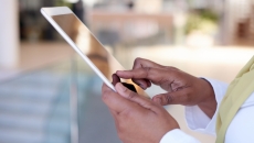 Someone holding a tablet near their torso