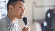 Person speaking in a microphone