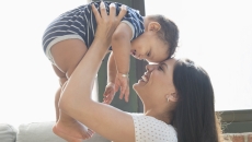 Person holding another smaller person above their head