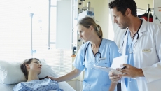 Healthcare professionals talking to a patient in a hospital