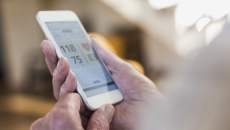 Photo of a smart phone showing blood pressure reading