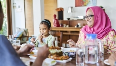 Family sitting at a table eating dinner