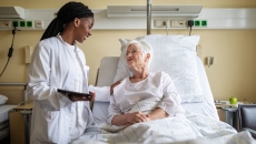 Healthcare professional consulting with a patient in the hospital
