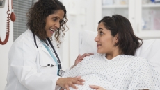 Healthcare professional consulting with pregnant patient
