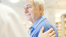 Person with a hand on his shoulder