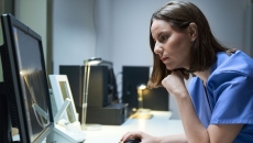 A doctor using a desktop computer.