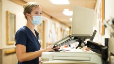 A nurse working at a computer in a hospital