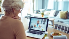 An older woman talking a doctor via telehealth