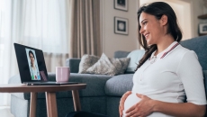 A pregnant person talks to a provider via telehealth