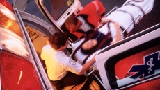 EMTs bringing a patient into an ambulance on a stretcher