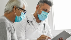 Healthcare provider and patient looking at a tablet