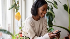 Person sitting in a chair while looking at a phone