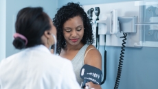 A person getting their blood pressure checked at the doctor's office.