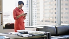 A person using a smartphone at a desk