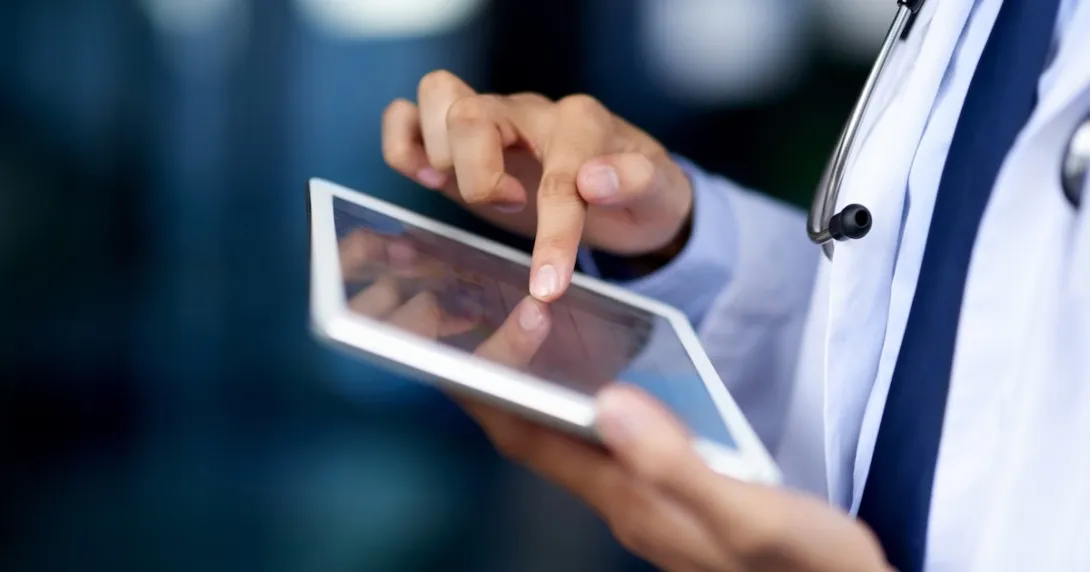 Clinician looking at a tablet computer
