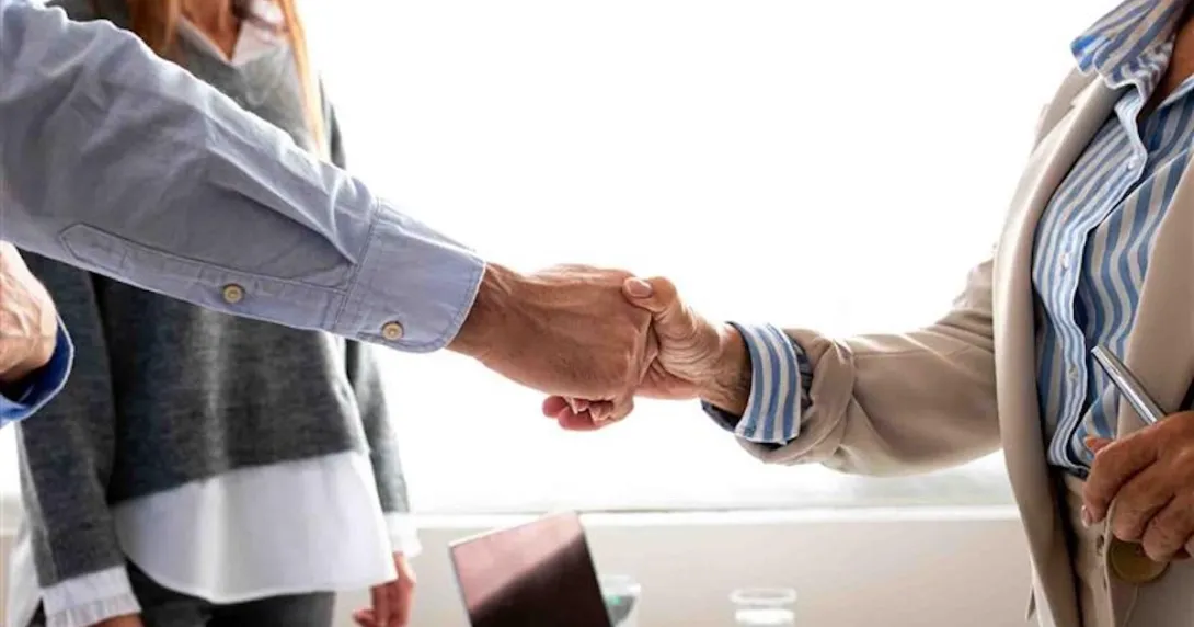Man and woman shaking hands in the office