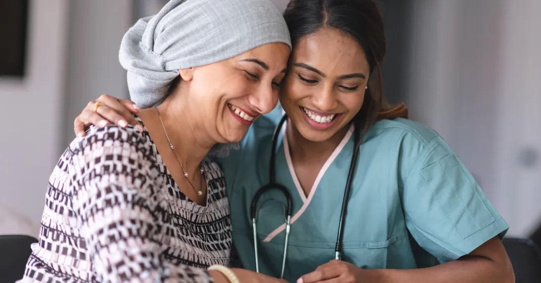 Healthcare provider sitting with a cancer care patient