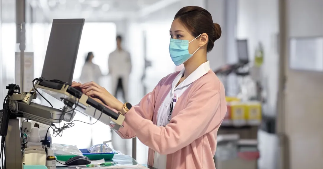 Healthcare provider in a clinic looking at a computer