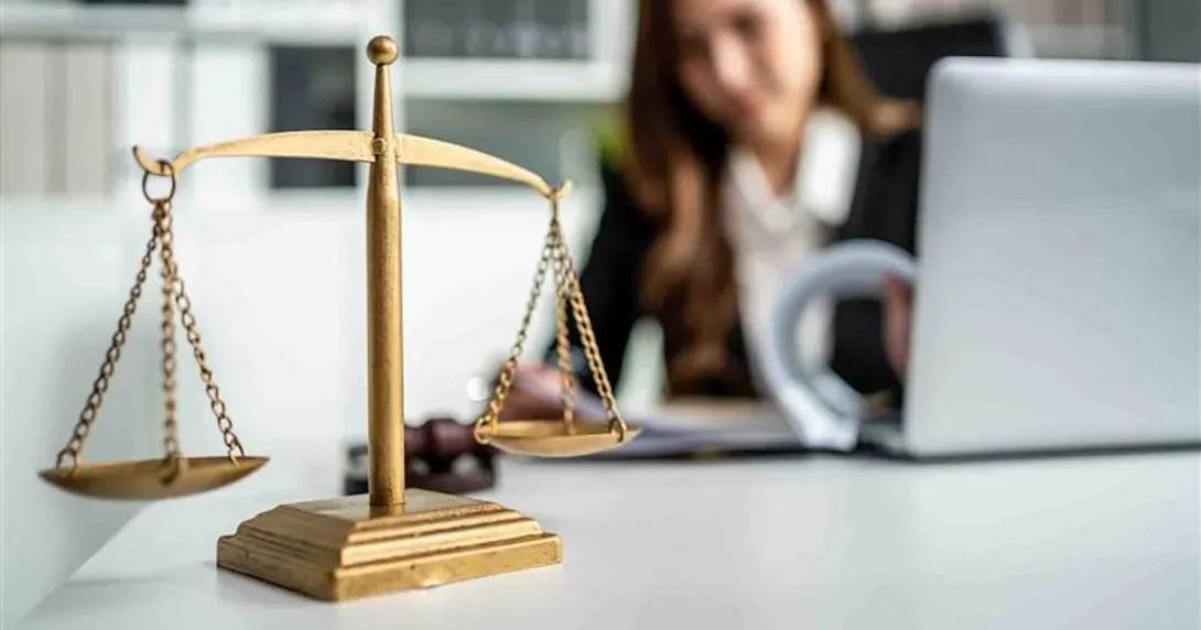 Shot of lawyer hammer and equality scales of justice in courtroom