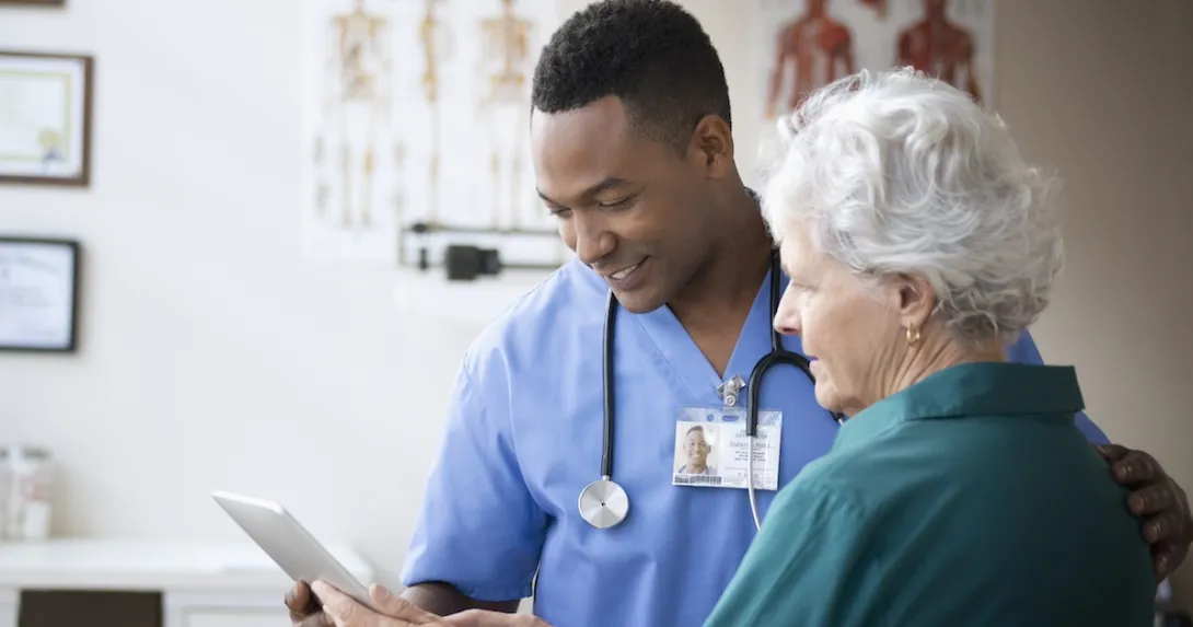 Health care team member reviewing medical history with patient