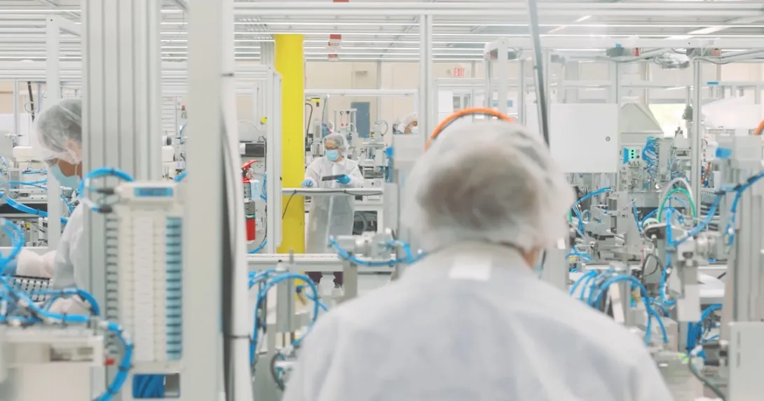 Workers in a Cue Health manufacturing facility