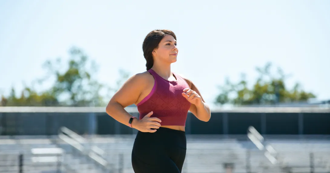A woman working out wearing a Fitbit Inspire 2