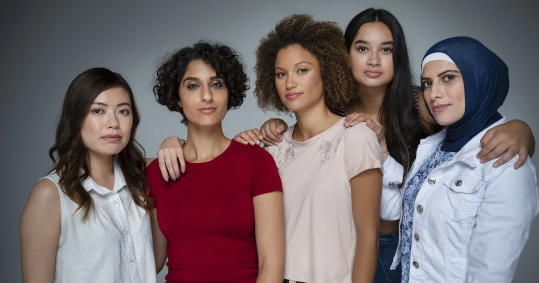 Five people standing in a group looking at the camera