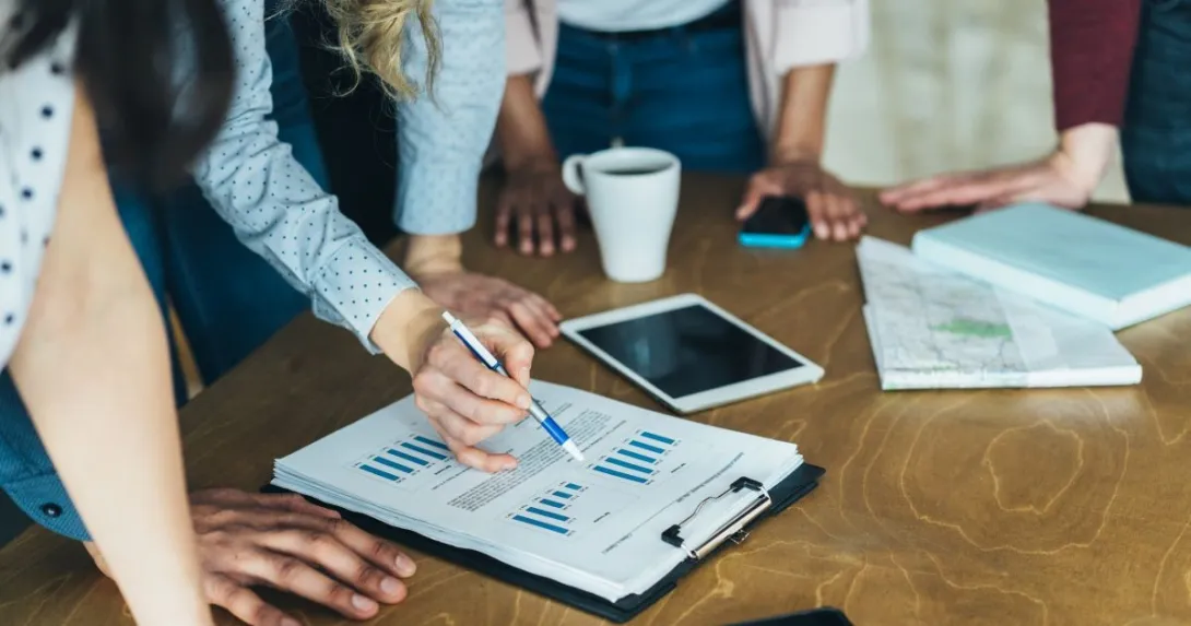 people looking at tablet, papers