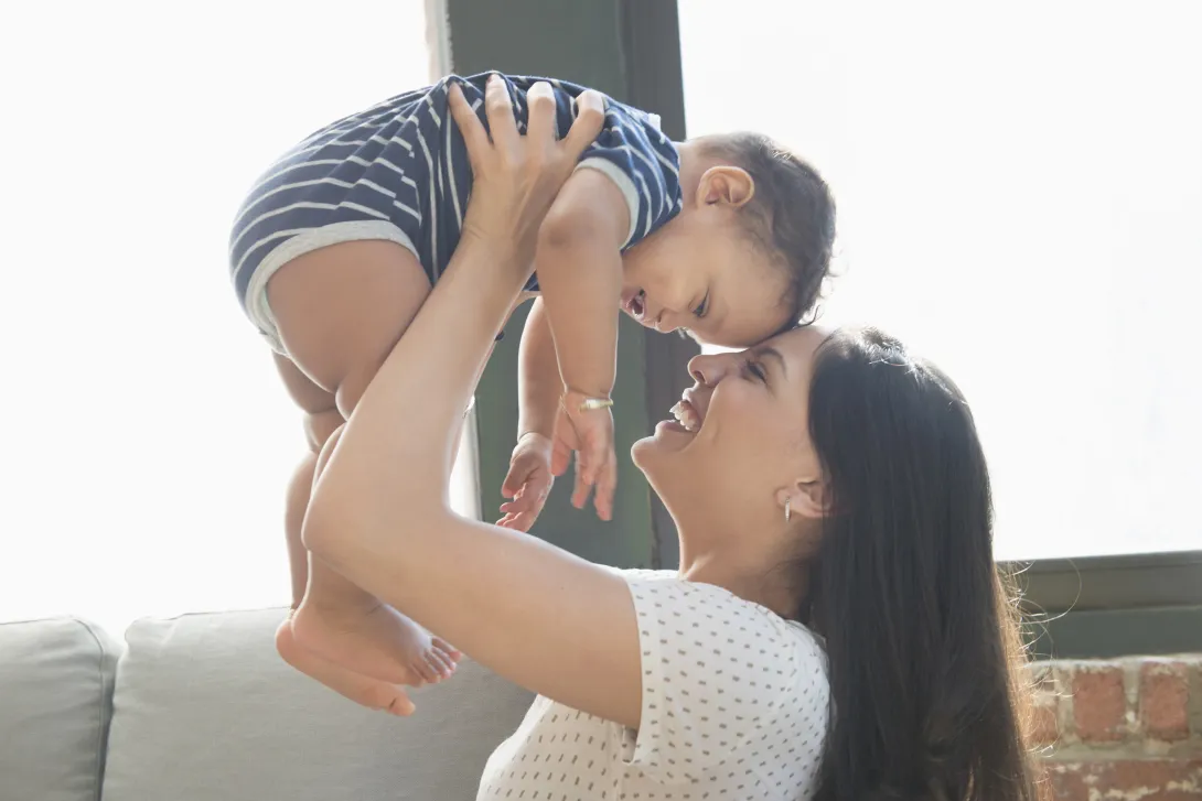 A young woman holding a baby.