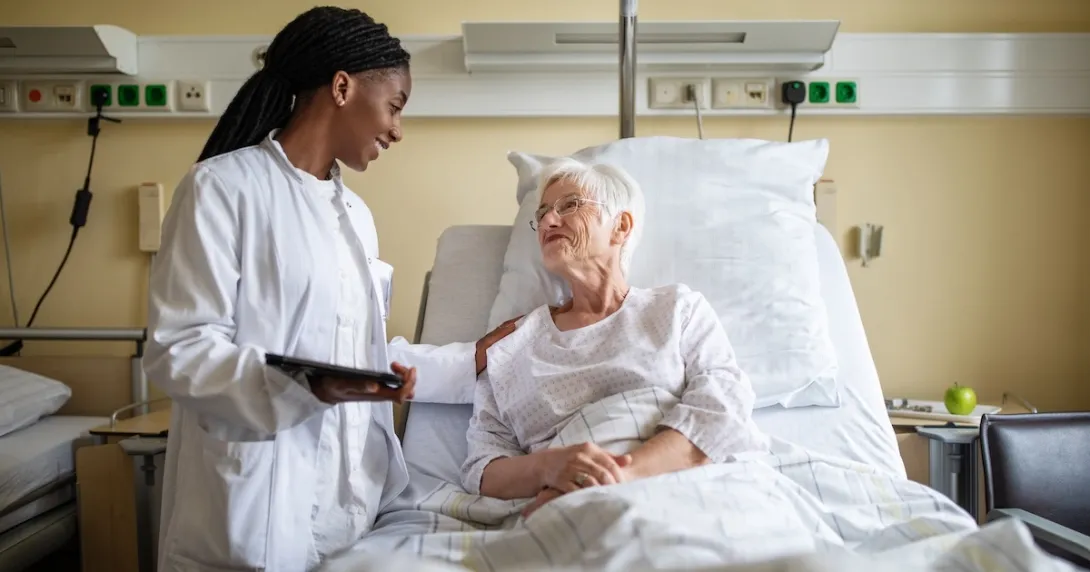 Healthcare professional consulting with a patient in the hospital