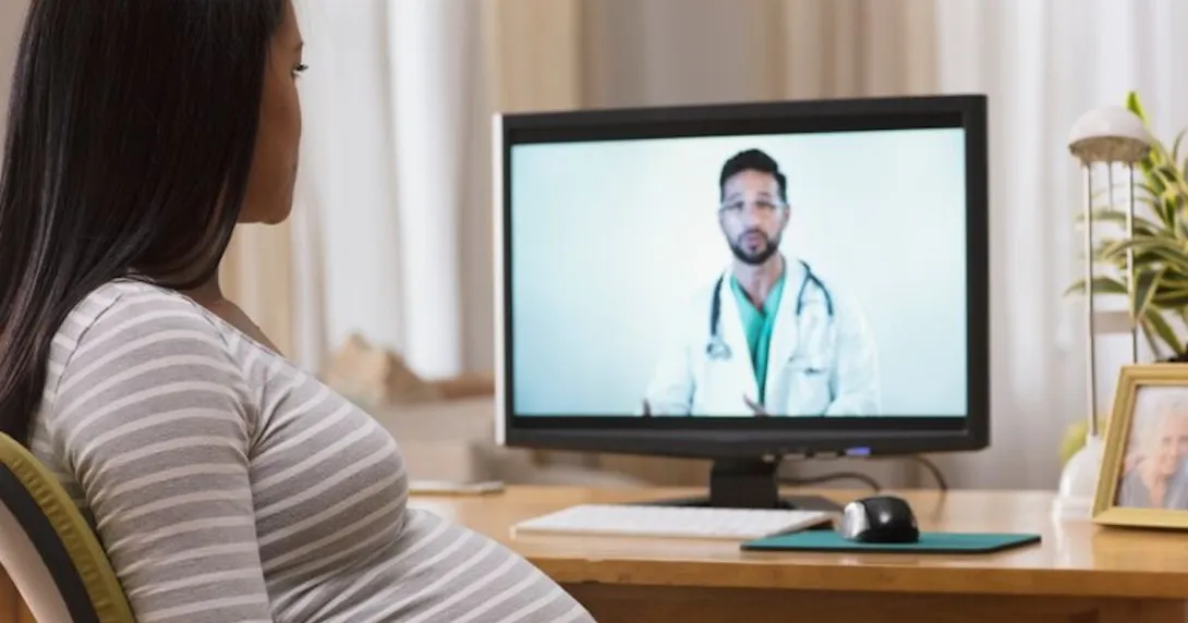 Pregnant person conferring remotely with a healthcare professional