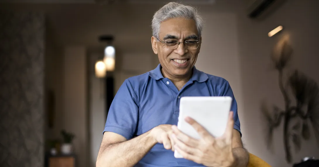 Person smiling while using a smart tablet