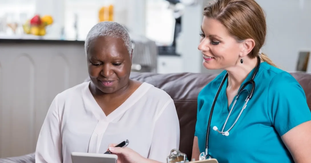Clinician reviewing healthcare information with a patient with a tablet