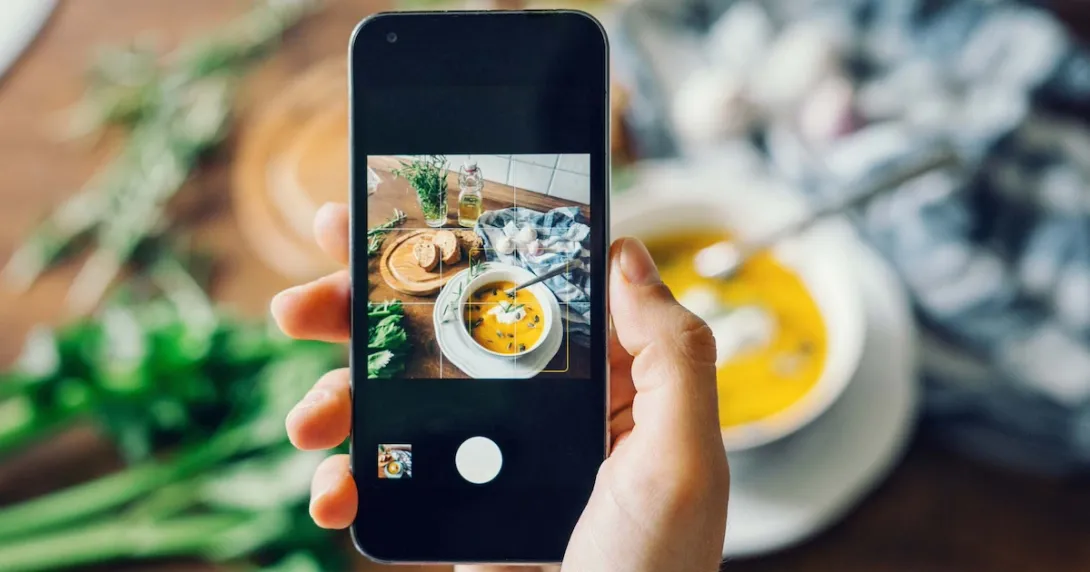 Person taking a photo of their meal with a smartphone