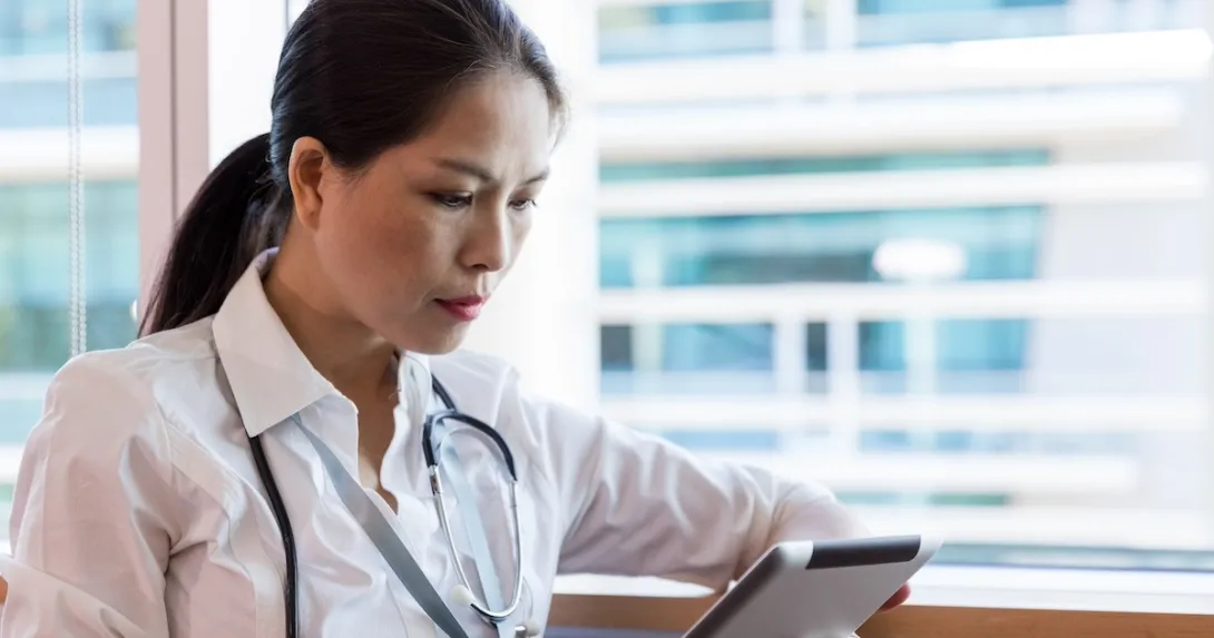 Healthcare practitioner reviewing EMR