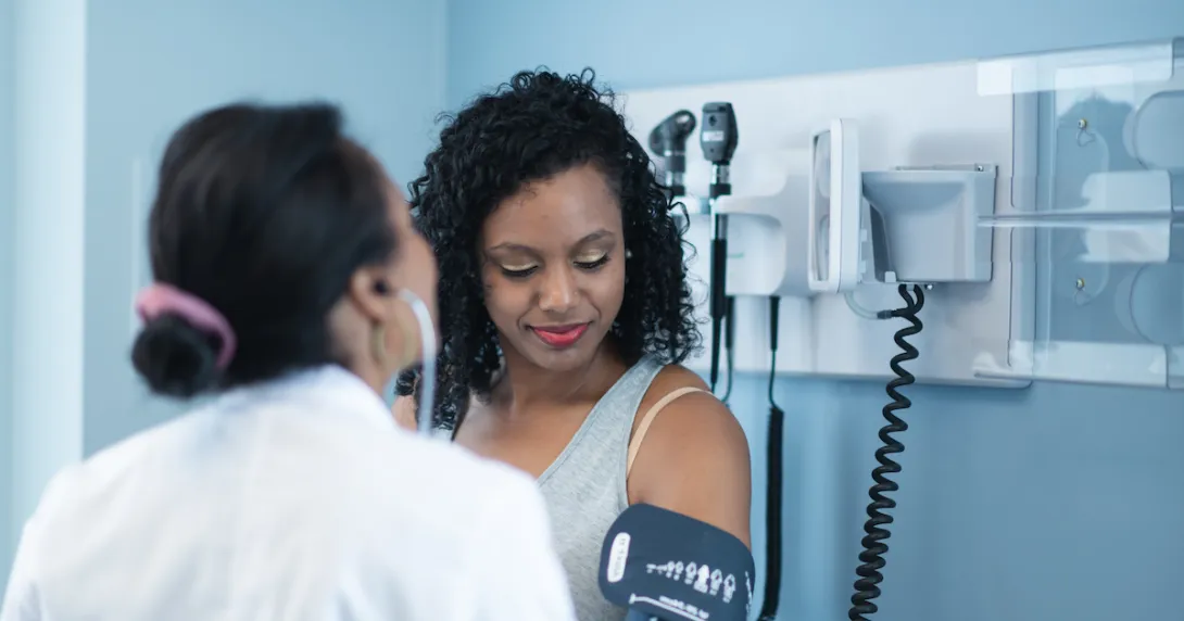 Doctor takes patient's blood pressure