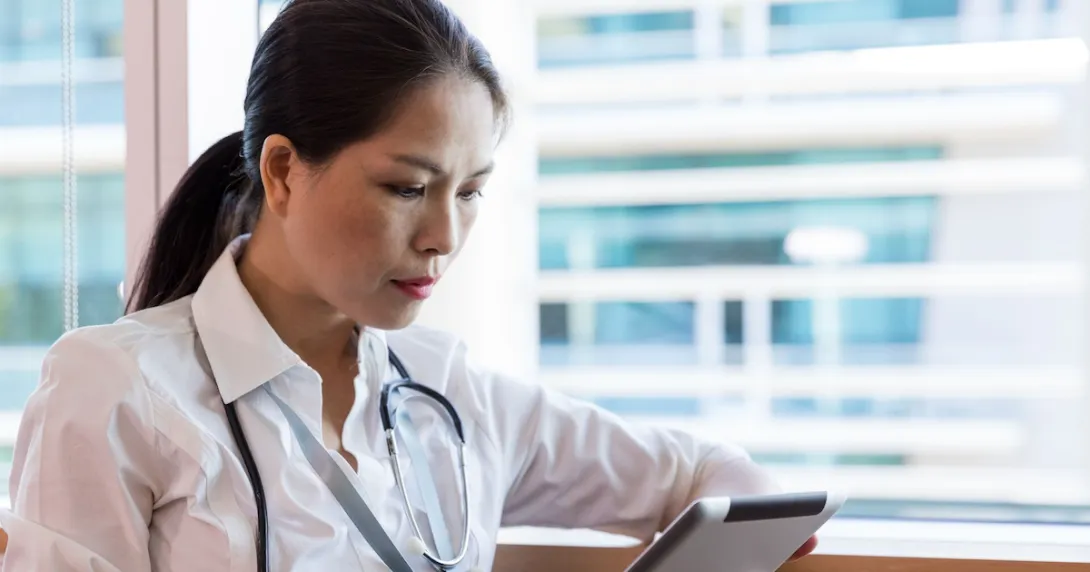 A clinician using a tablet.
