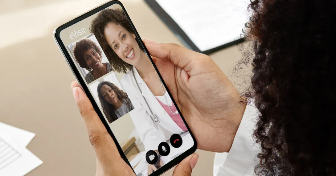 A close up of a woman holding a smartphone during an eVisit telehealth consultation