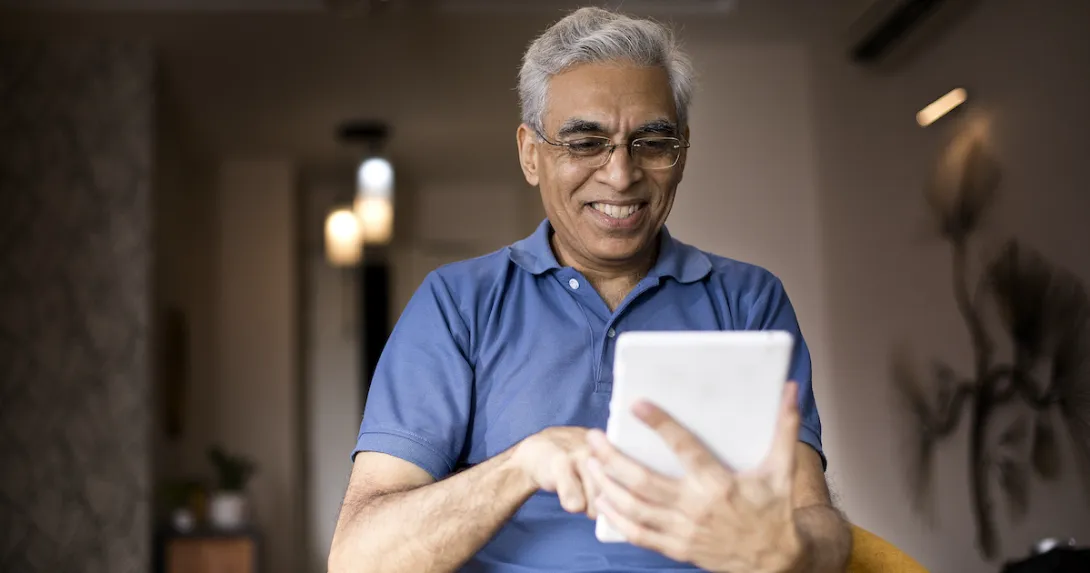 An older man using a tablet