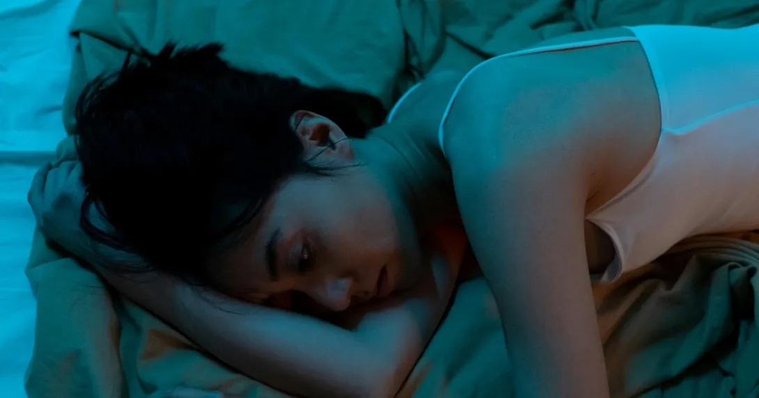 A seemingly depressed person lying in bed