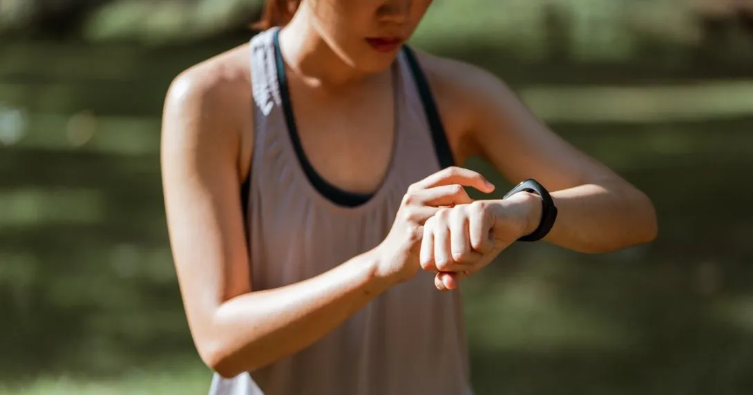 A person looking at their wearable tracker